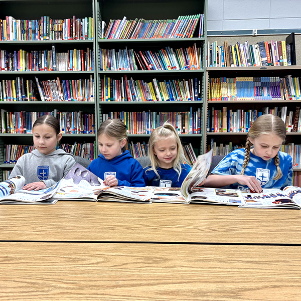 Four girls studying in the library.